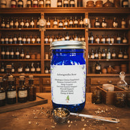 Blue jar of Ashwagandha Root with a label on a textured surface.