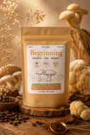 A stand-up pouch of mushroom coffee labeled 'Becoming' on a rustic wooden surface, surrounded by dried flowers, coffee beans, a spoon of ground coffee, and mushrooms in a warm beige and brown setting.